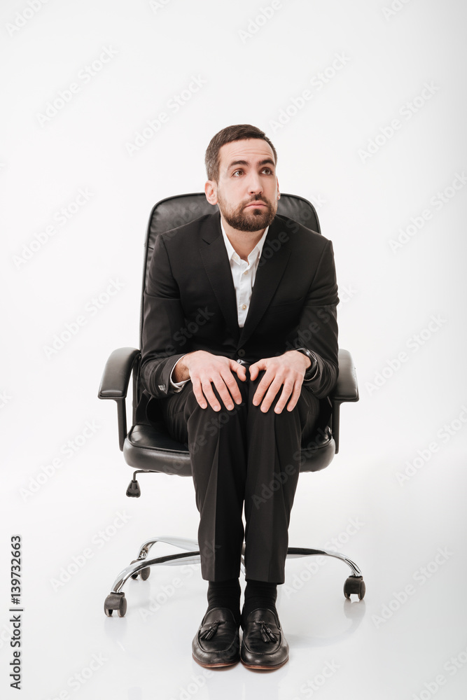 Handsome businessman over white background sitting on chair. Handsome businessman over white background sitting on chair.