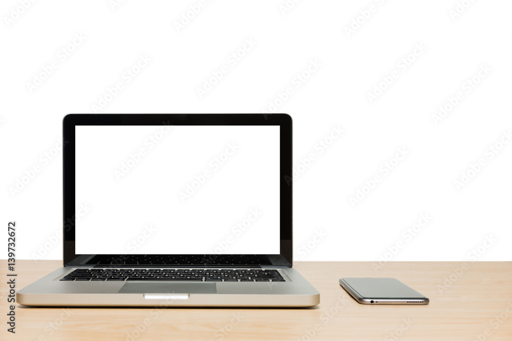 Open laptop with isolated white screen and mobile phone on wooden Open laptop with isolated white screen and mobile phone on wooden