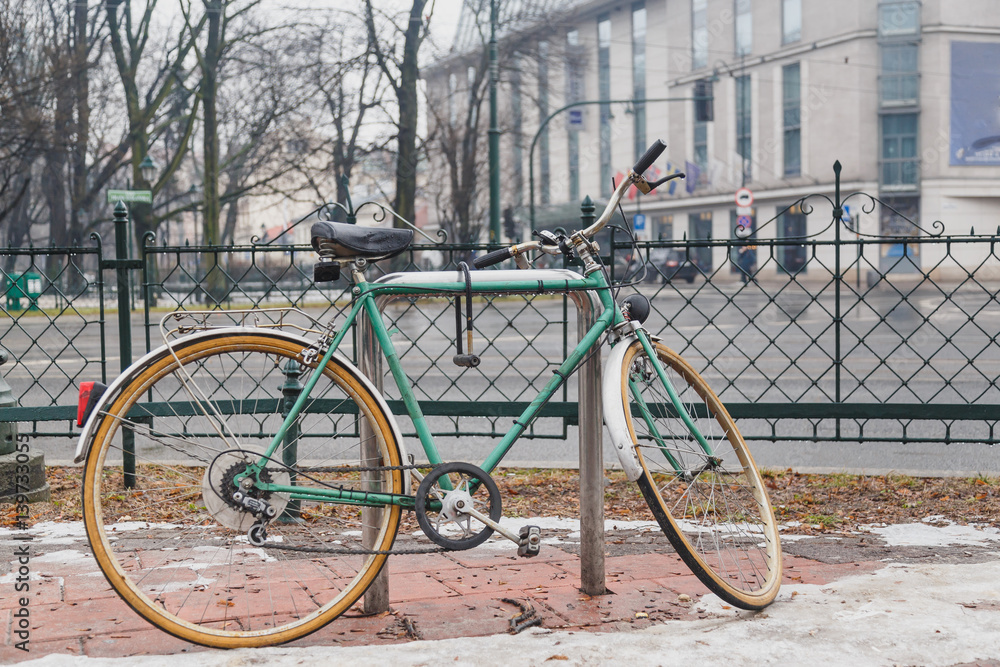 Fototapeta premium Urban green Bicycle parked in the street.