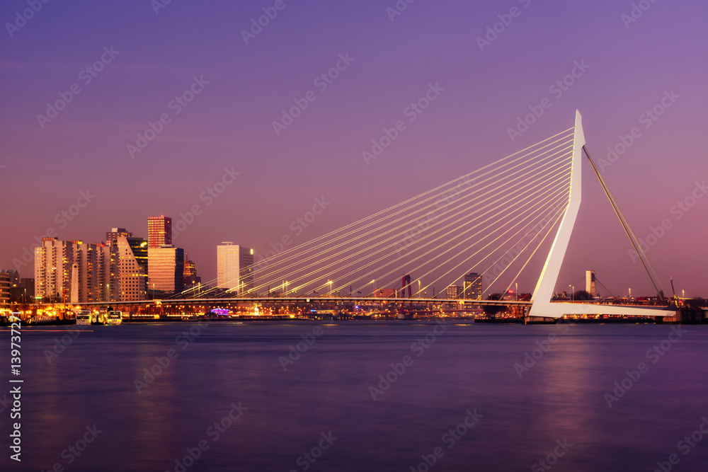 Amazing sunset view of Erasmus bridge and several skyscrapers in Rotterdam, Holland.