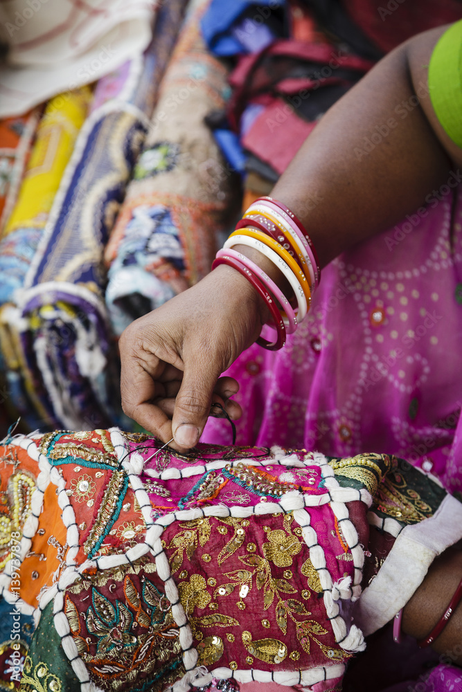 Woman weaving colourful fabrics at Mapusa Market, Goa, India. Woman weaving colourful fabrics at Mapusa Market, Goa, India.