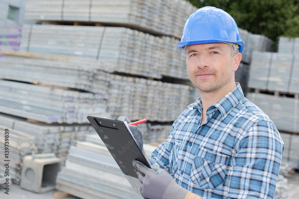 man writing an inventory report