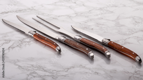 Set of kitchen knifes on a marble, top view. Table knives