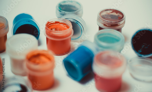 Colorful sample paint pots on white