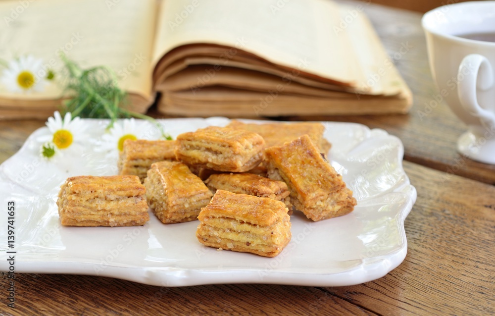 Homemade flaky biscuits on the table in garden. Homemade flaky biscuits on the table in garden.