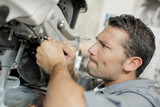 mechanic repairing an engine