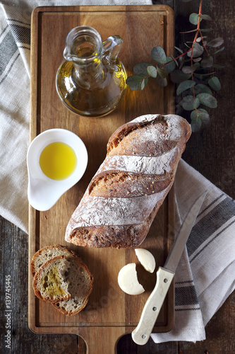 French country bread, cheese and olive oil. Top view photo