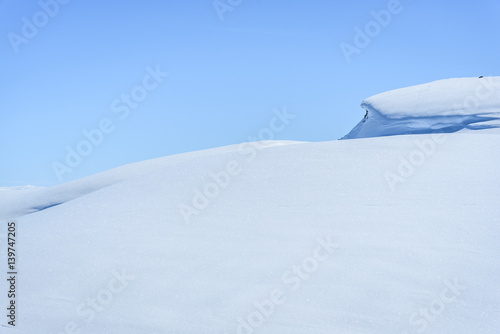 Clear sunny sky in a winter landscape in snow covered mountains © Inger