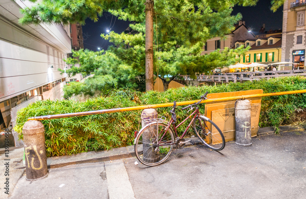 MILANO, ITALY - SEPTEMBER 25, 2015: Bike parked along Navigli at night. Milan attracts 5 million tourists annually