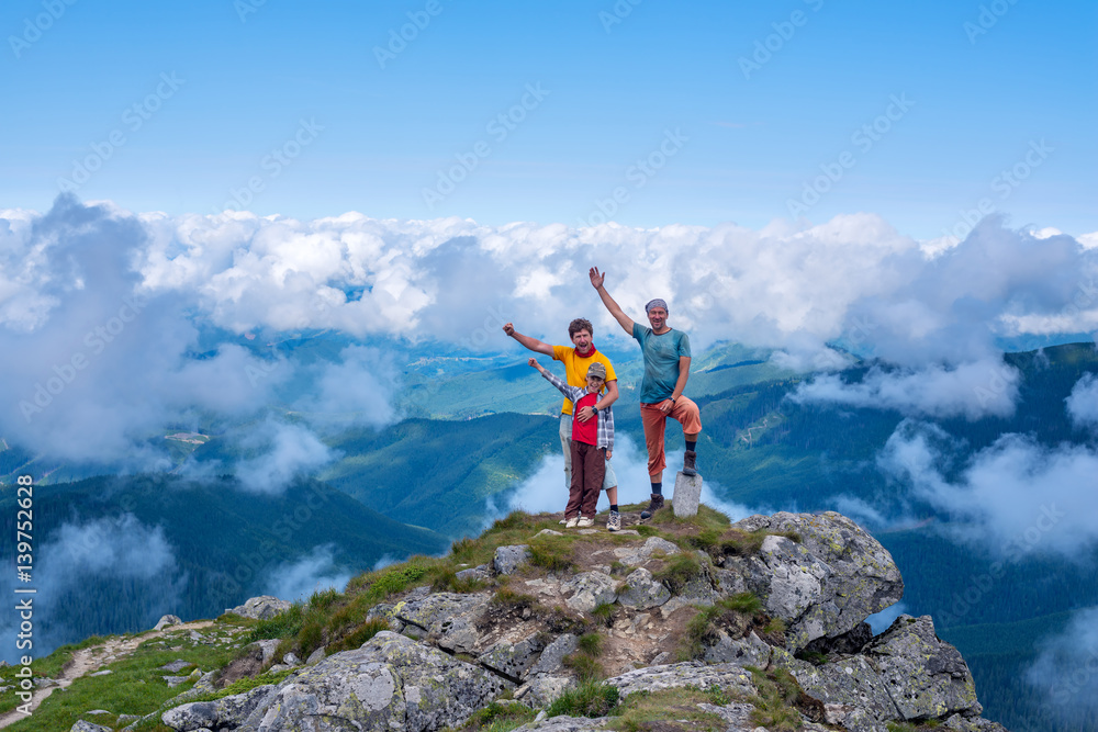 Proud and happy travelers on top of the mountain