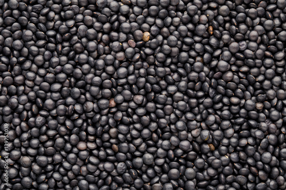 Food and cookery background of healthy dried black lentils. Food and cookery background of healthy dried black lentils.
