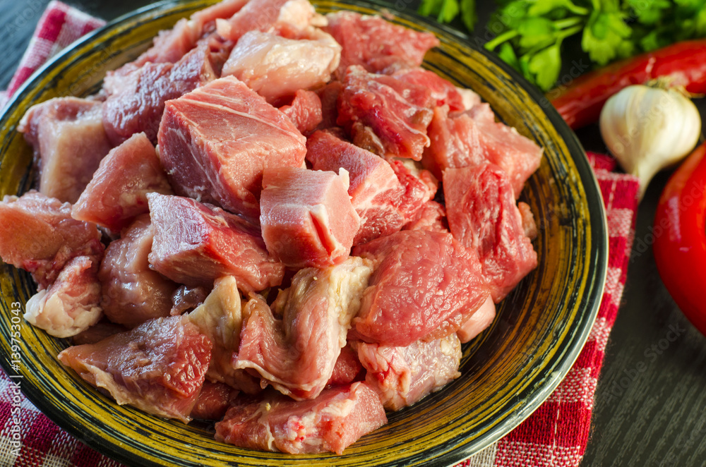 Raw meat chopped into pieces on a plate Raw meat chopped into pieces on a plate