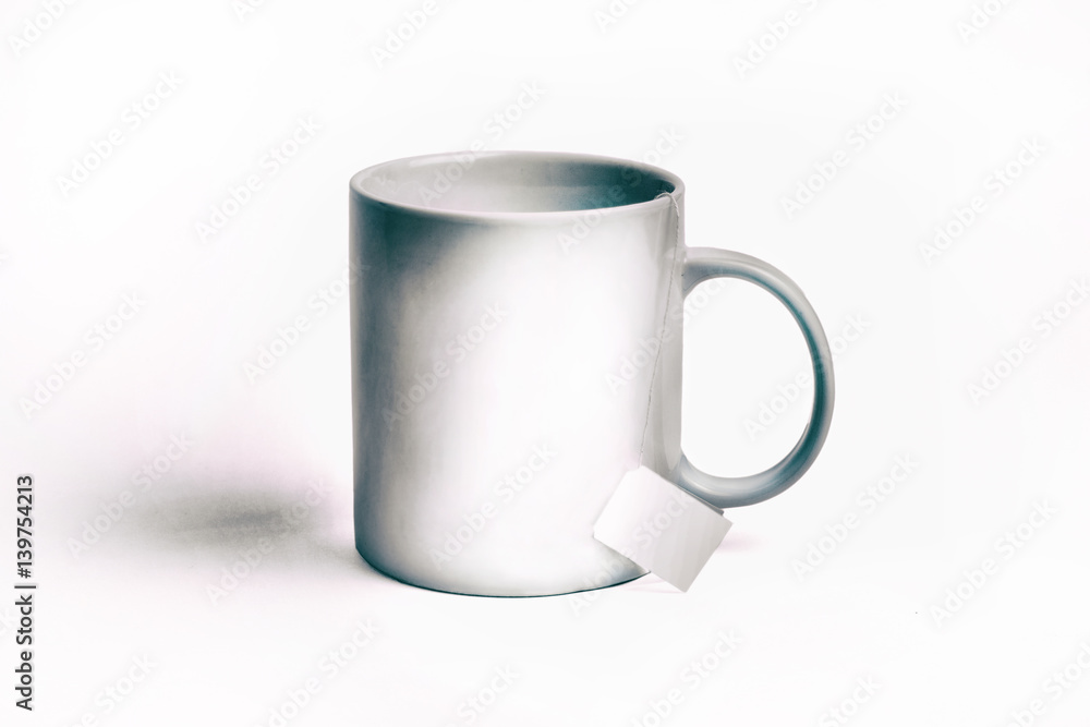 Obraz premium white cup and bag of tea. isolated on white background. Mockup for designs. toned