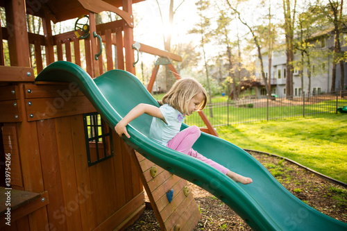 Girl sliding down slide