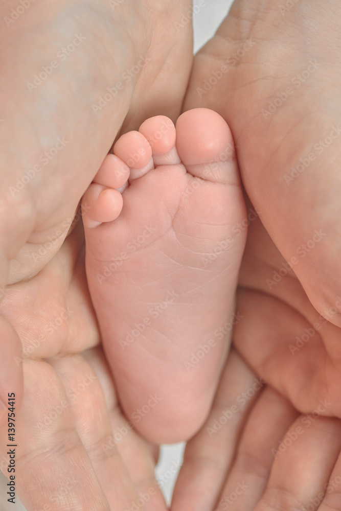Parent holding in the hands foot of newborn baby Parent holding in the hands foot of newborn baby