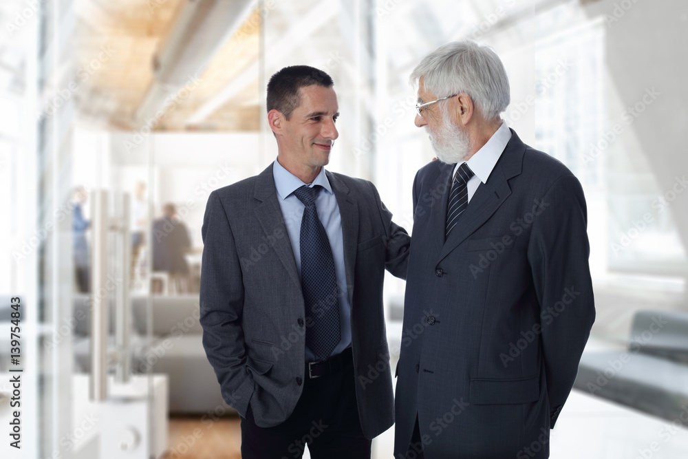 Business meeting success and teamwork concept. Young and mature businessmen together working on project