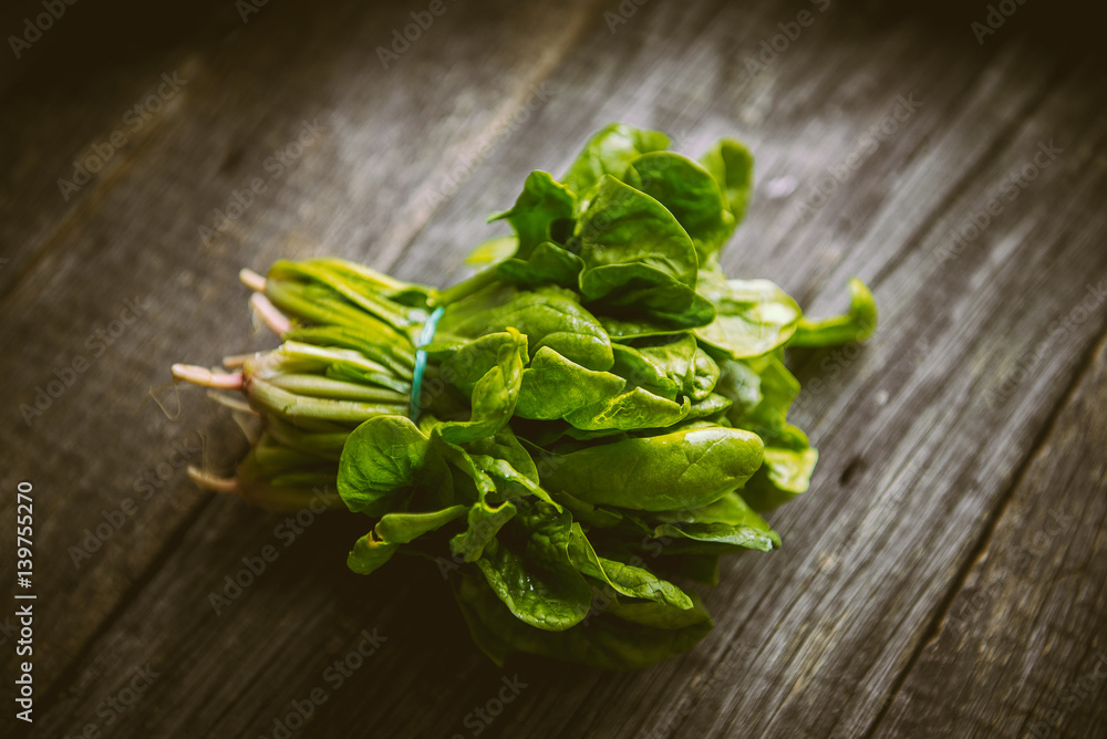 Fresh washed organic spinach on a cutting board Fresh washed organic spinach on a cutting board