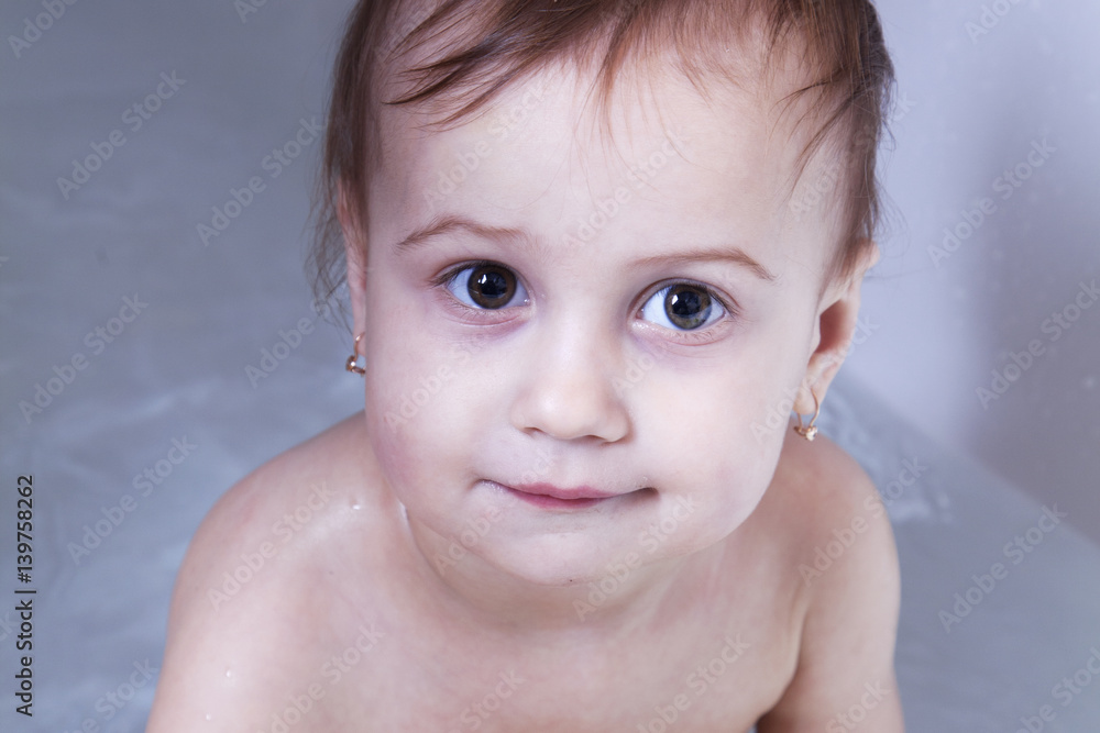 Beautiful baby girl playing with water in the bath Beautiful baby girl playing with water in the bath