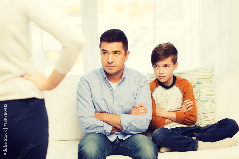 upset or displeased father, son and mother at home upset or displeased father, son and mother at home