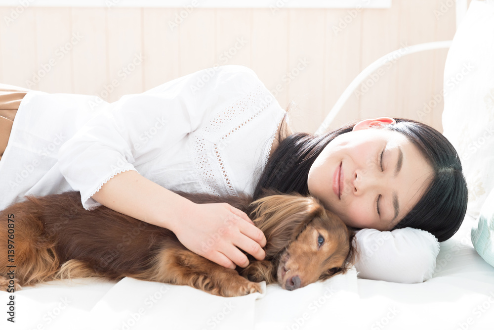 young asian woman sleeping with dog young asian woman sleeping with dog