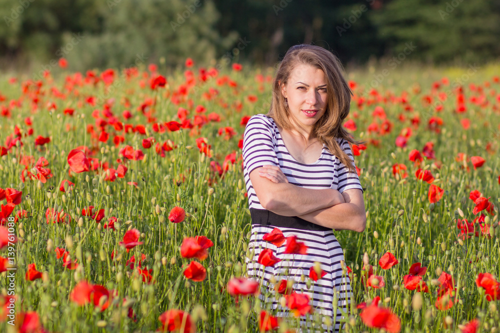 Smiling young woman on poppy field Smiling young woman on poppy field