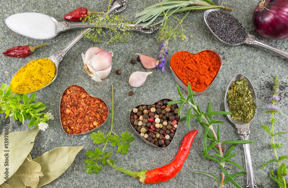 Bunch of spices and vegetables on stone background