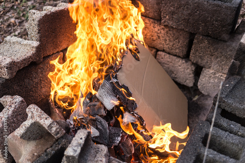 Burning Newspaper or Cardboard in Burning Pit with Flames