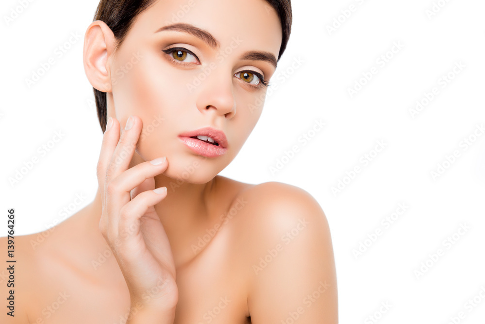 An attractive girl with perfect skin and minimum of makeup touching with fingers her face An attractive girl with perfect skin and minimum of makeup touching with fingers her face