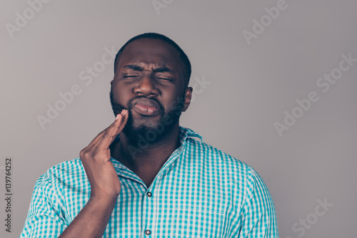 Tableau sur toile Portrait of bearded   afroamerican man touch cheek
