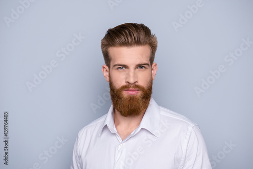 Portrait of confident bearded man in white shirt