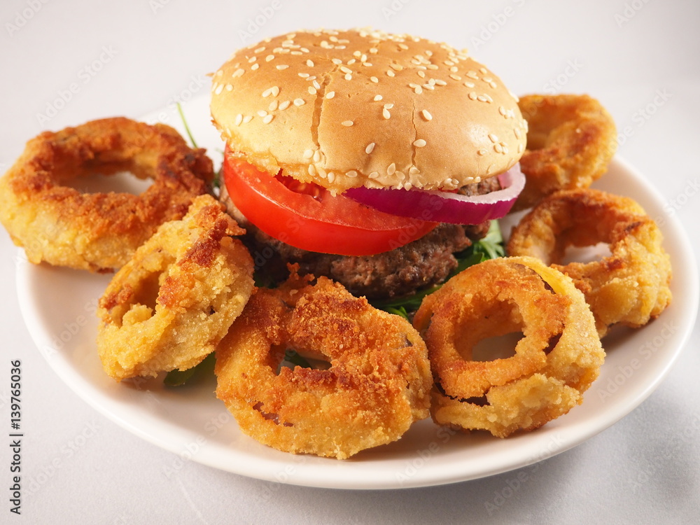 Hamburger with onion, tomato and lettuce. American fast food. Hamburger with onion, tomato and lettuce. American fast food.