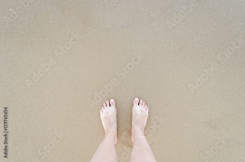 Beautiful bare feet on the beach