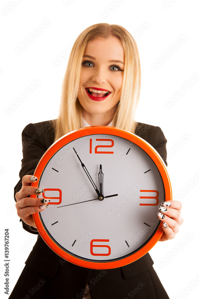 Beautiful business woman holds a clock as a sign for time management isolated over white Beautiful business woman holds a clock as a sign for time management isolated over white