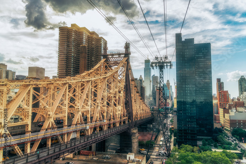 NEW YORK CITY, USA: The Queensboro Bridge is a two-level double cantilever bridge. It has two cantilever spans, one over the channel on each side of Roosevelt Island. Vivid image.