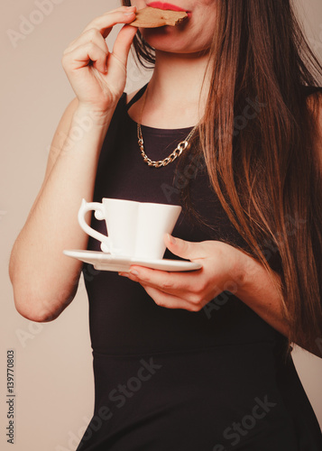 Woman with cup of coffee and cake