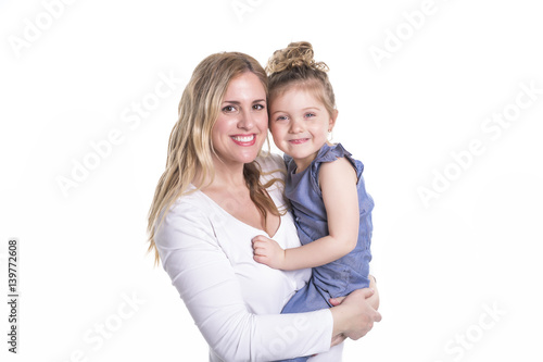young mother hugging her little daughter isolated on white