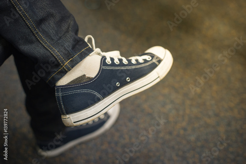 Young fashion man's legs with sneakers 