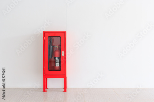 Fire Extinguisher in red Cabinet on Wall for fire protection in factory manufacturing with copy space.