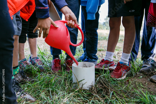 Kids observe experiment with water during a field trip to a local farm.
