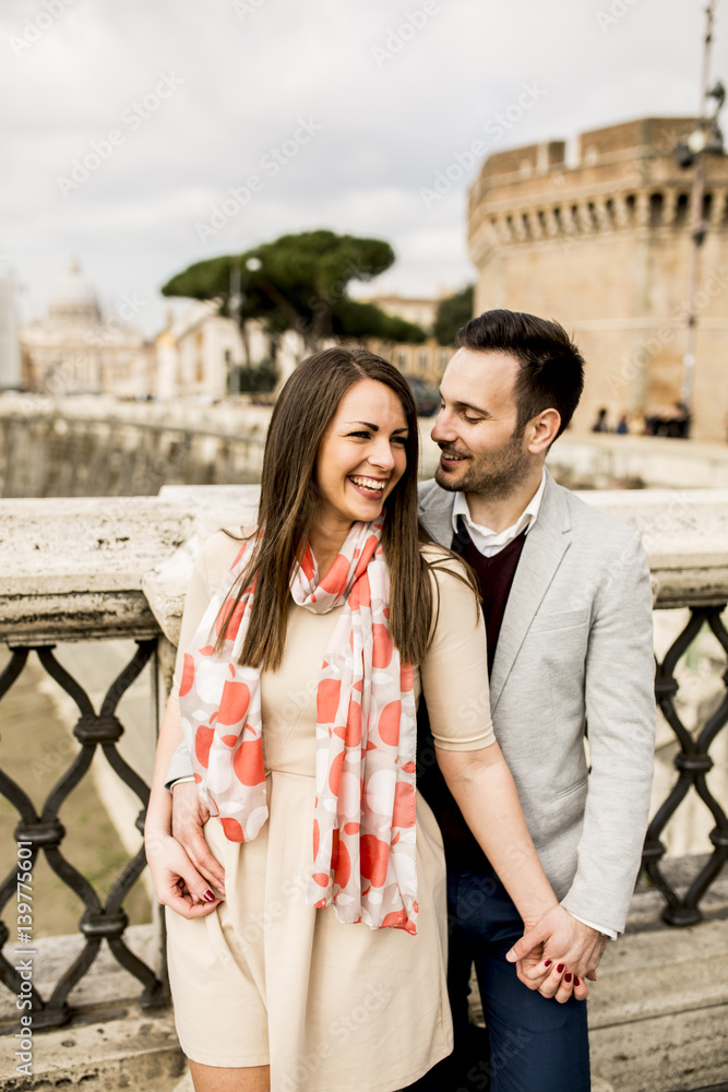 Loving couple by the Castel Sant'Angelo in Rome, Italy