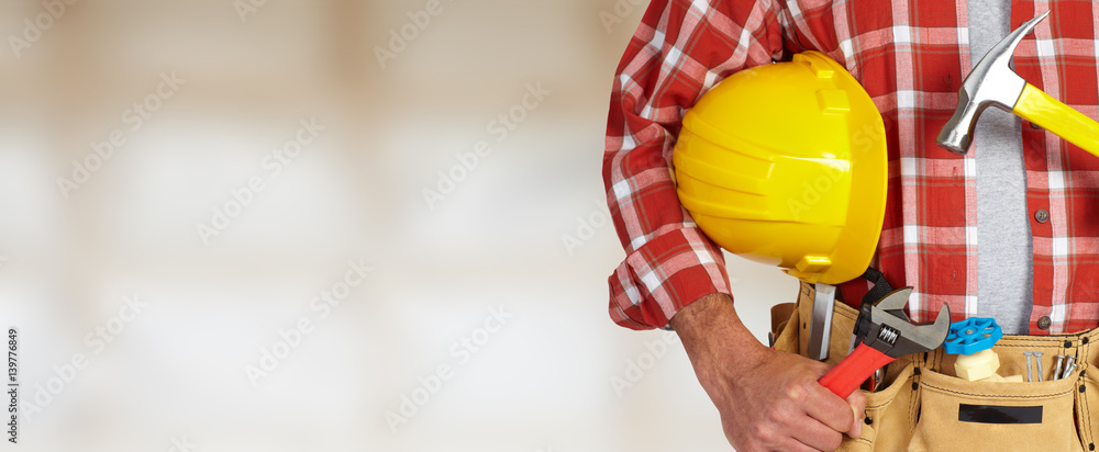 Builder handyman with construction tools. Builder handyman with construction tools.