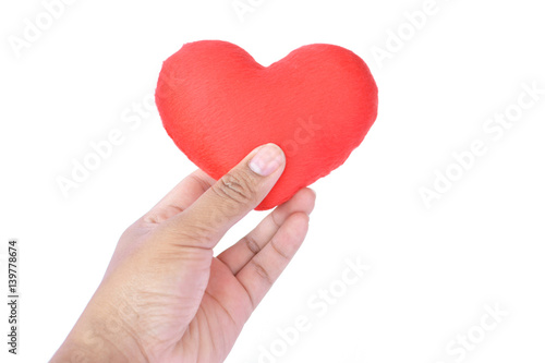 Hand holding red heart shape on white background