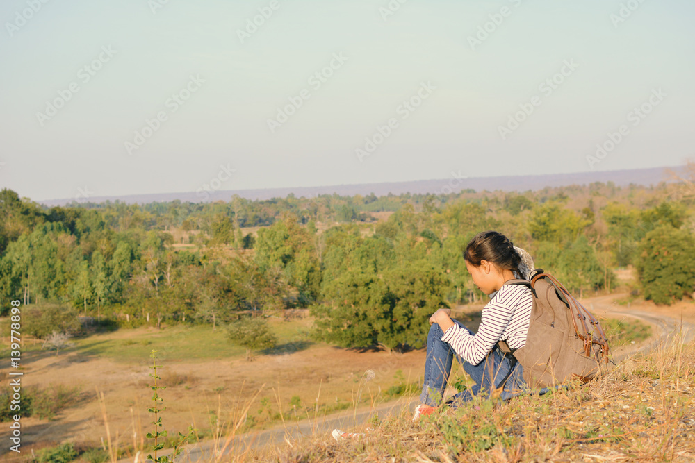 Happy Asian girl backpack  in nature background, Relax time on holiday concept travel ,color of vintage tone and soft focus