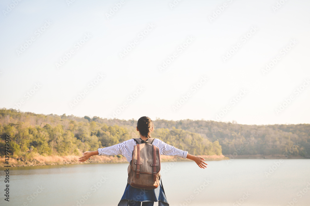 Happy Asian girl backpack in nature background, Relax time on holiday concept travel ,color of vintage tone and soft focus Happy Asian girl backpack in nature background, Relax time on holiday concept travel ,color of vintage tone and soft focus