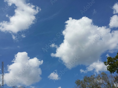 Beautiful fluffy clouds on blue sky background © natalya2015