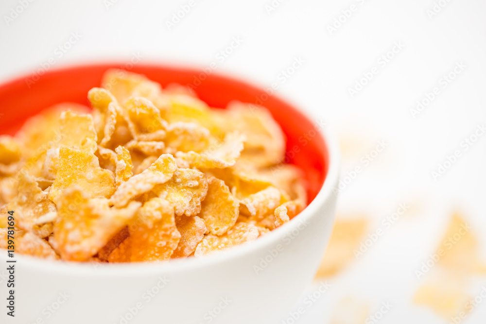 bowl of sugar-coated corn flakes isolated on white. bowl of sugar-coated corn flakes isolated on white.