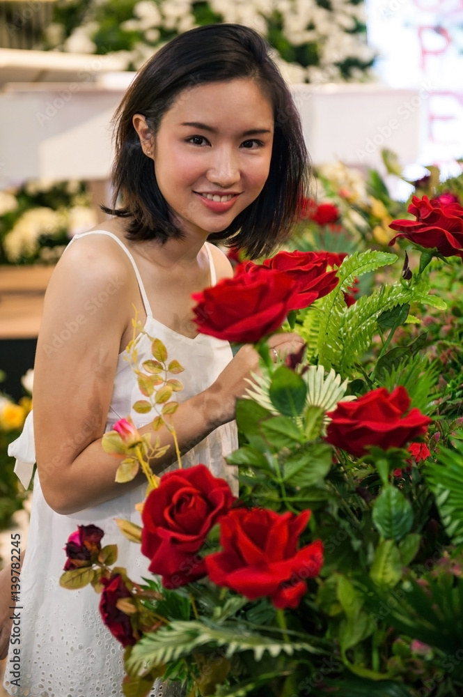 women walk in rose garden set up for valentine festival. women walk in rose garden set up for valentine festival.