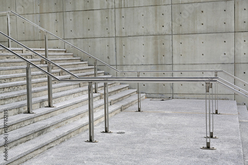 Stone stairs steps background with aluminium handle