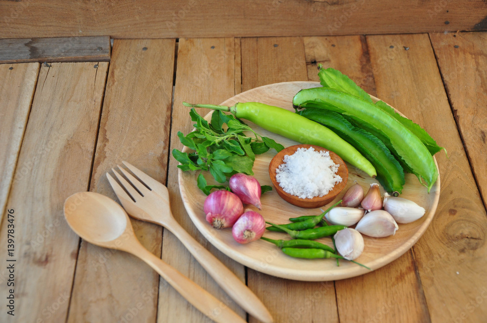 ingradian. vegetable ingradian. red onion, winged bean, besil leaf, garic, chilli and salt is on a wooden plate. ingradian. vegetable ingradian. red onion, winged bean, besil leaf, garic, chilli and salt is on a wooden plate.