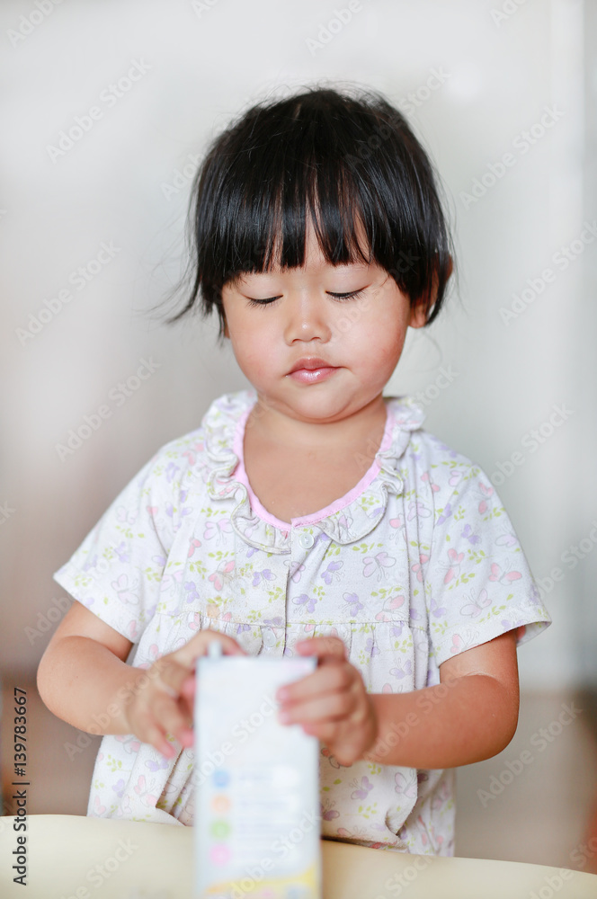 Closeup of little girl drinking milk with straw. Closeup of little girl drinking milk with straw.